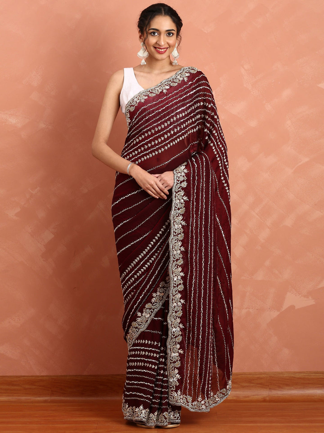 Neerus Maroon hand embroidered saree with Swarovski and cut dana - front view