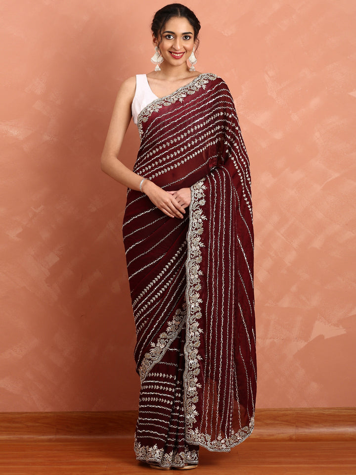 Neerus Maroon hand embroidered saree with Swarovski and cut dana - front view