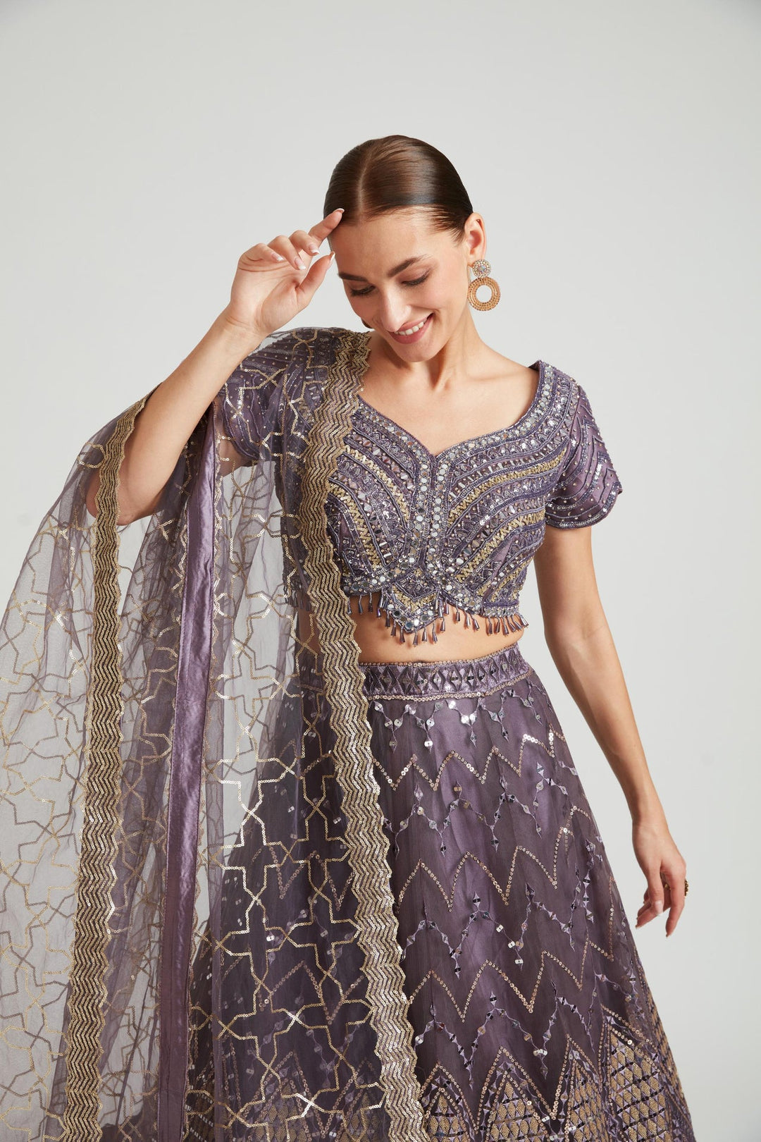 Neerus Purple net embellished lehenga choli set - side view