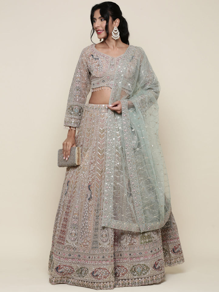 Beige net heavy embroidered three piece ghagra set