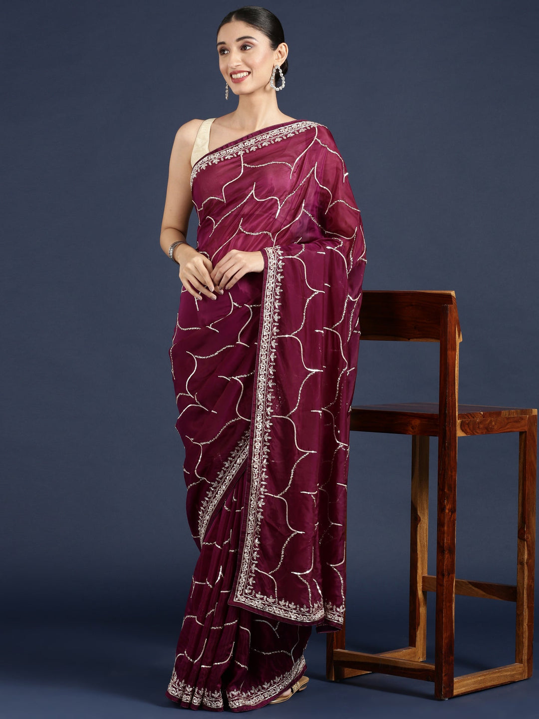 Neerus Maroon satin embellished saree - back view
