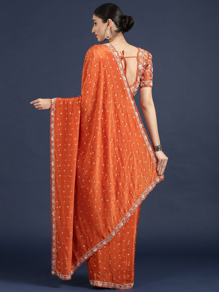 Neerus Orange crepe embellished saree with readymade blouse - back view