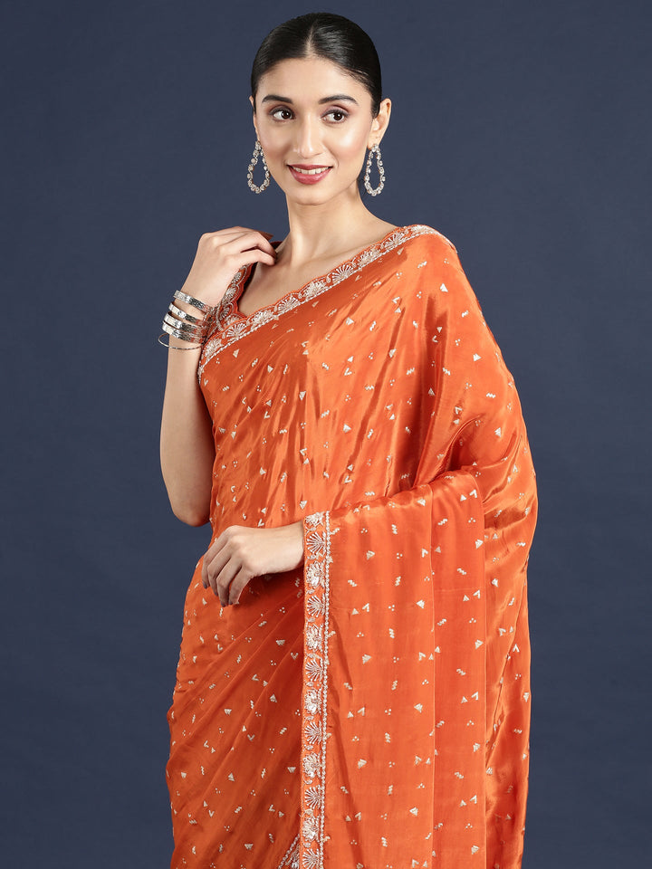 Neerus Orange crepe embellished saree with readymade blouse - side view