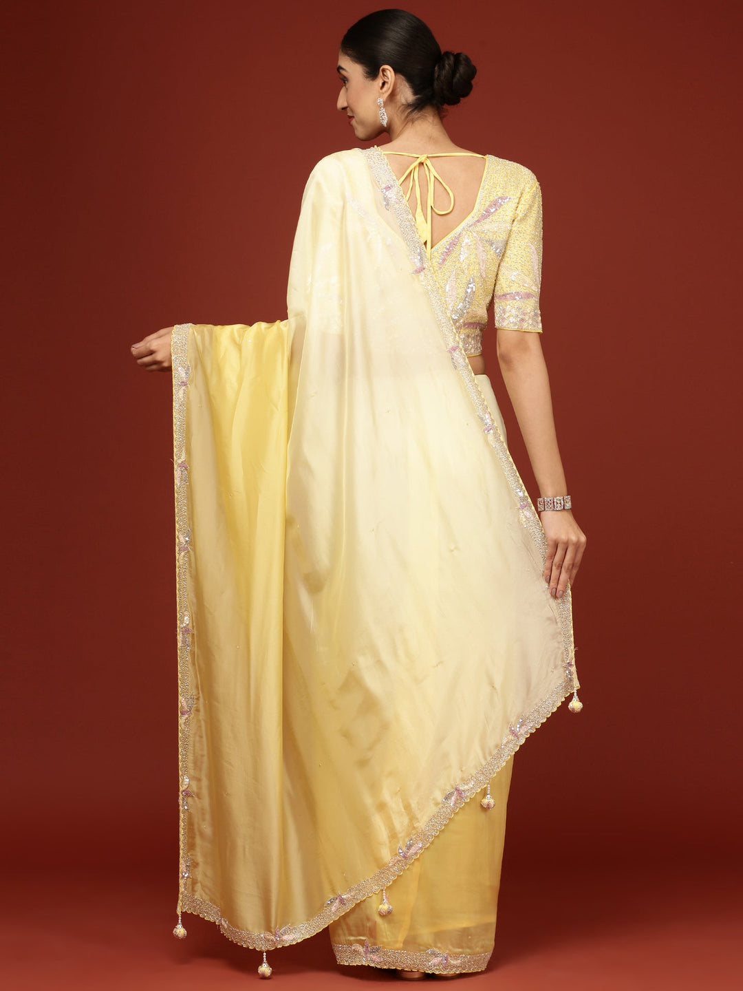 Neerus Yellow crepe embellished saree with readymade blouse - side view