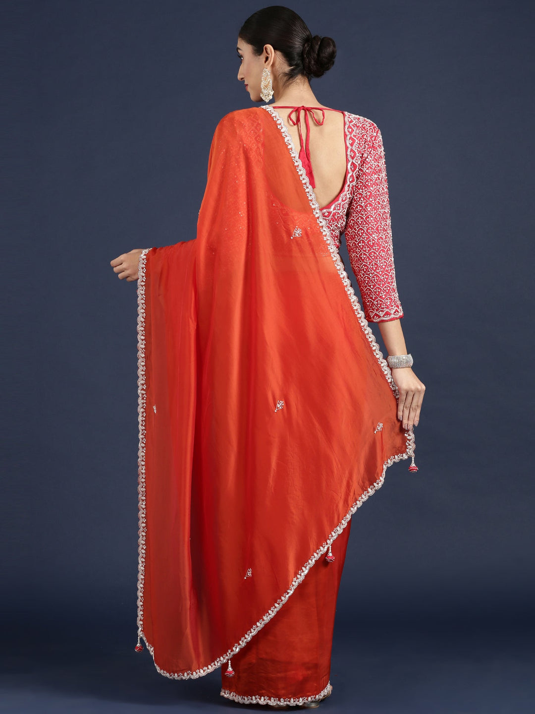 Neerus Orange crepe embellished saree with readymade blouse - side view