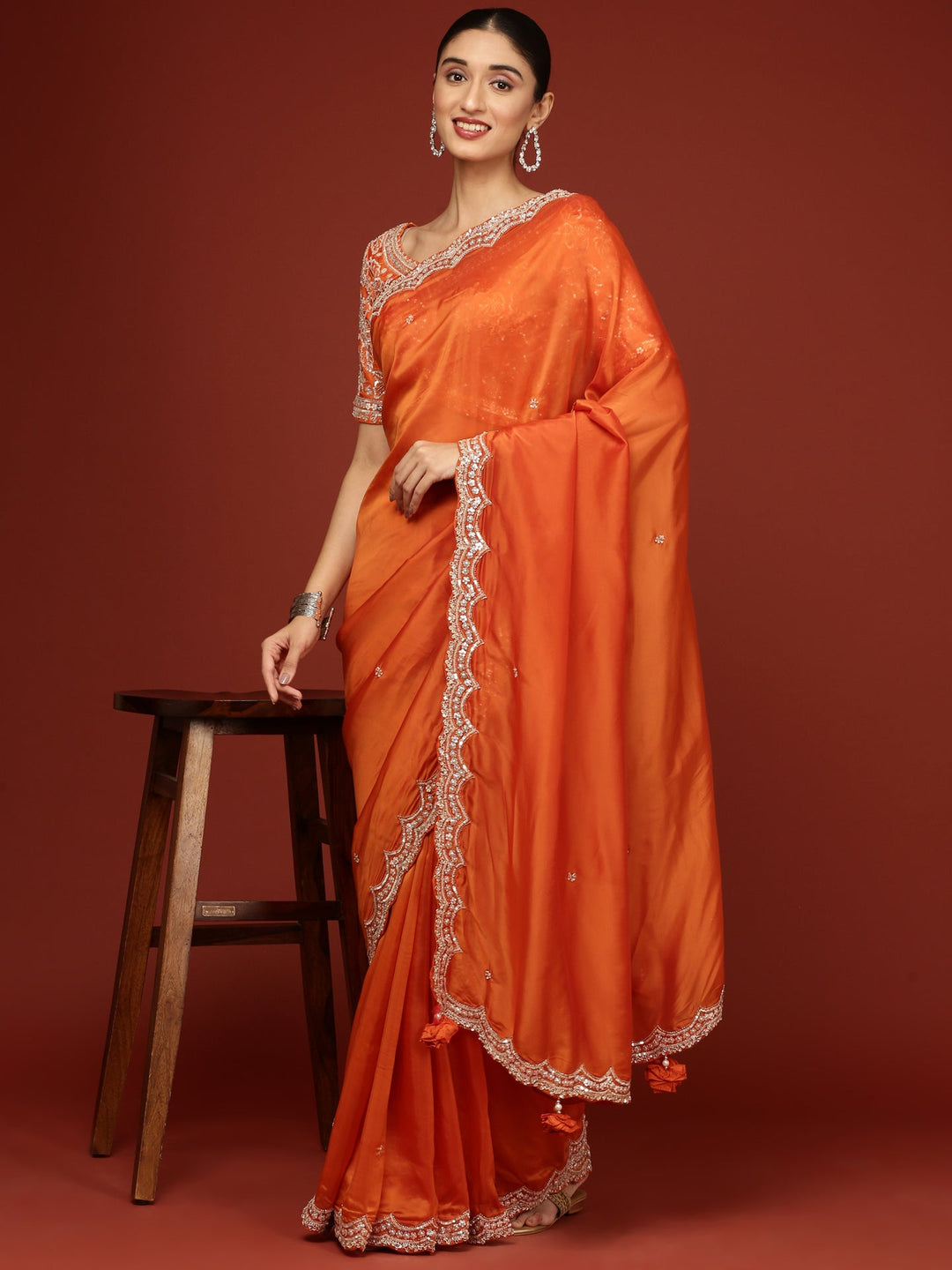 Neerus Orange crepe embellished saree with readymade blouse - back view