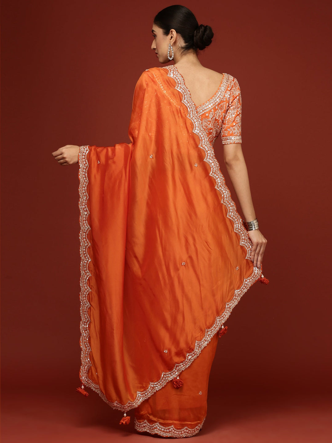Neerus Orange crepe embellished saree with readymade blouse - side view