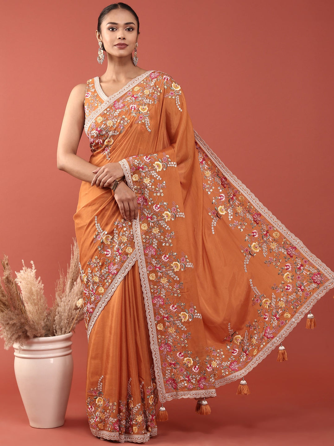 Neerus Orange crepe embroidered saree with blouse - front view