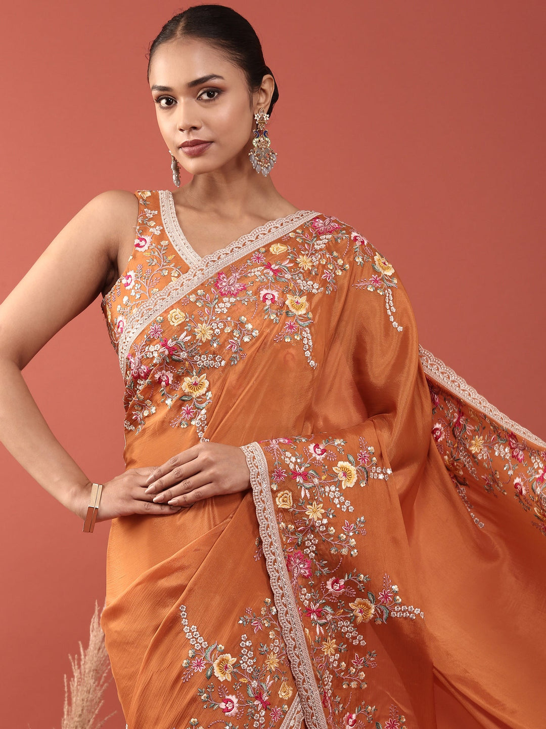 Neerus Orange crepe embroidered saree with blouse - side view