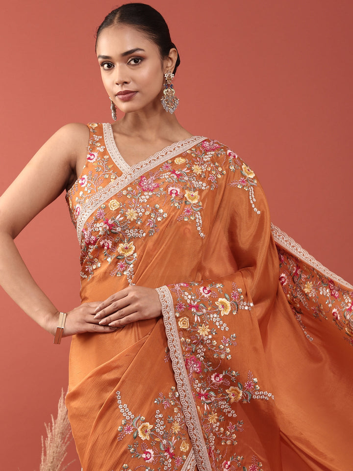 Neerus Orange crepe embroidered saree with blouse - side view