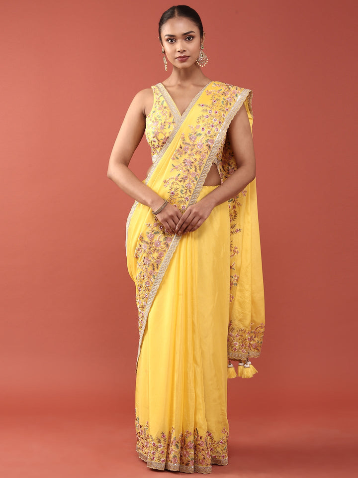 Neerus Yellow crepe embroidered saree with blouse - front view