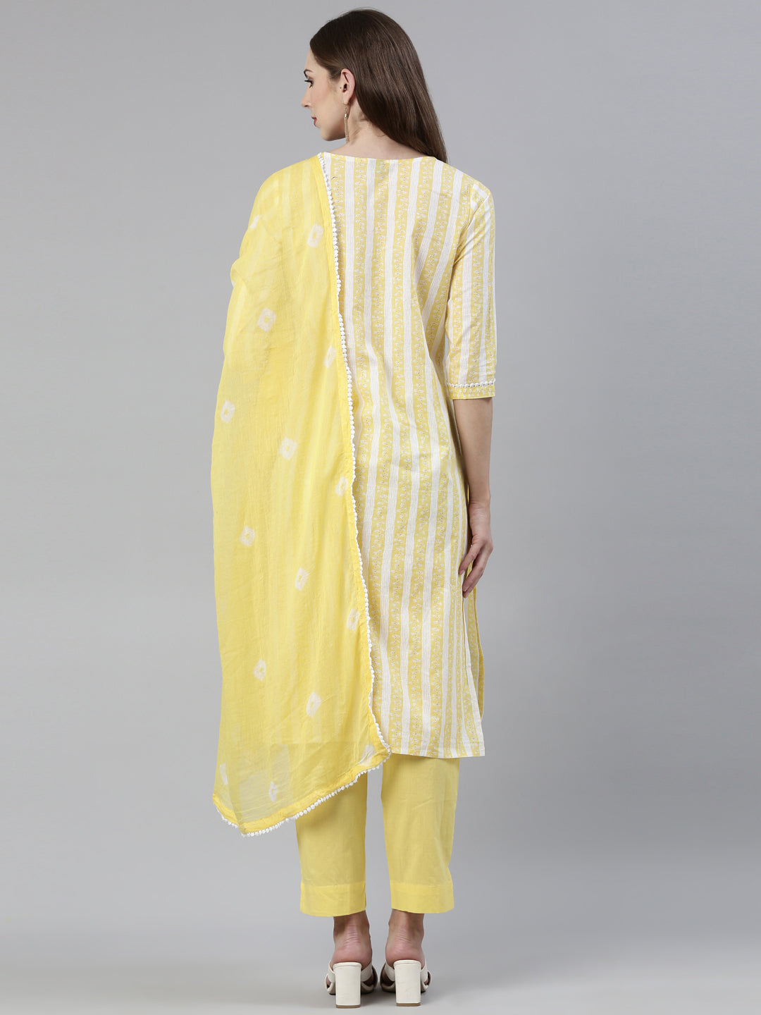 Neerus Yellow solid straight kurta set with trouser and dupatta - side view